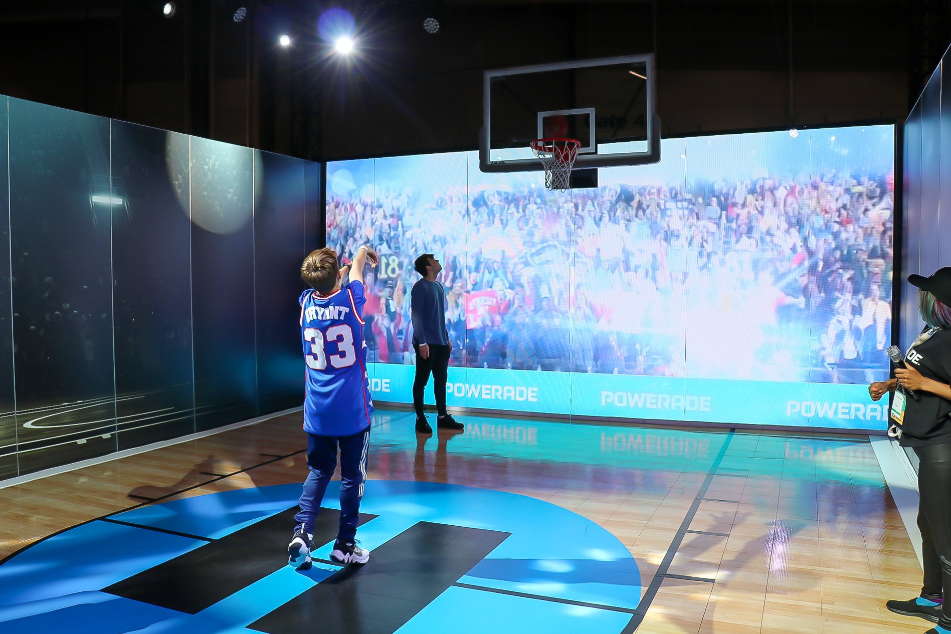 A boy wearing a McDonald's All Star jersey for Kobe Bryant shoots a basketball  from the free throw line.