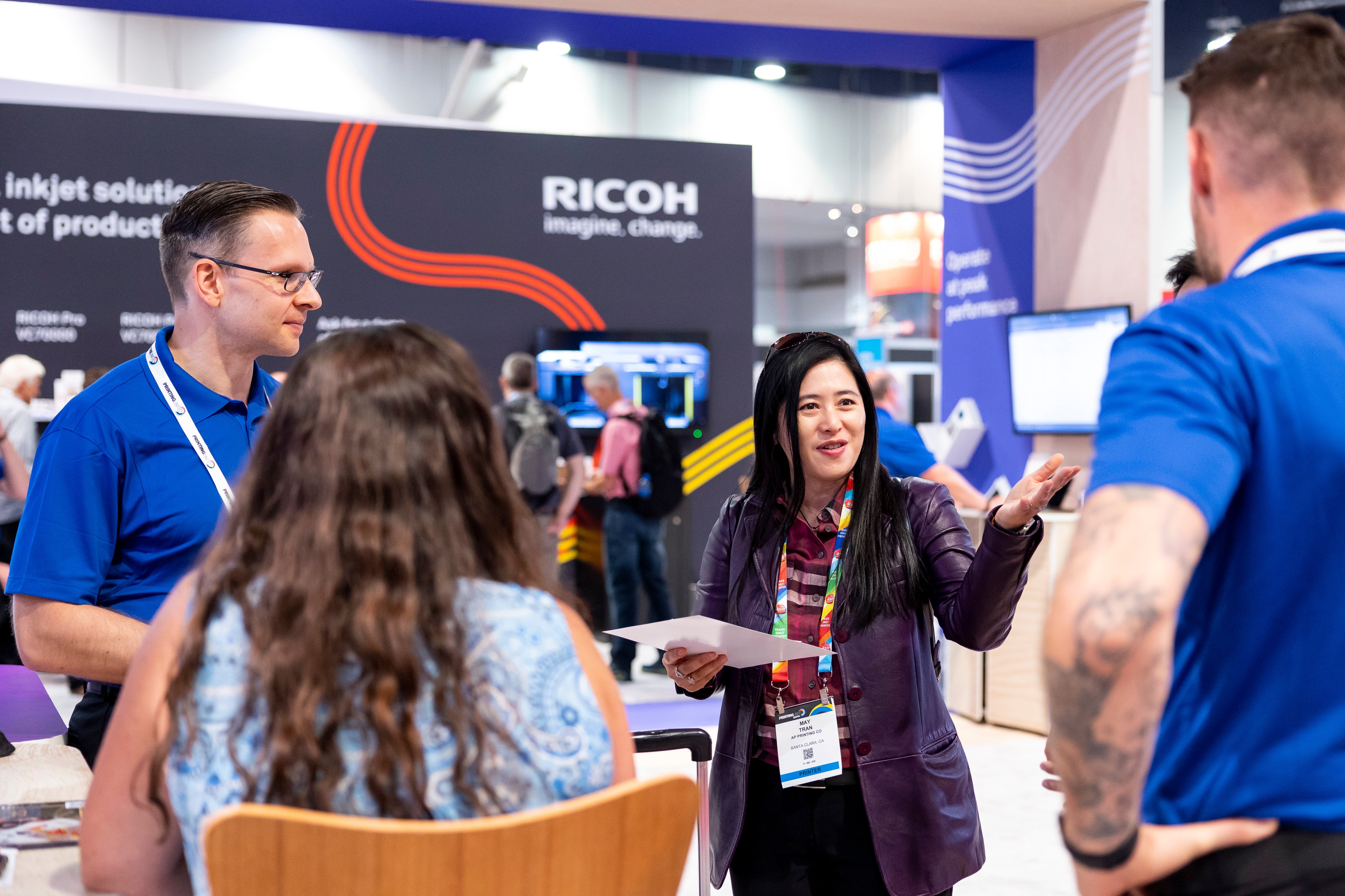 Woman presenting at Ricoh booth