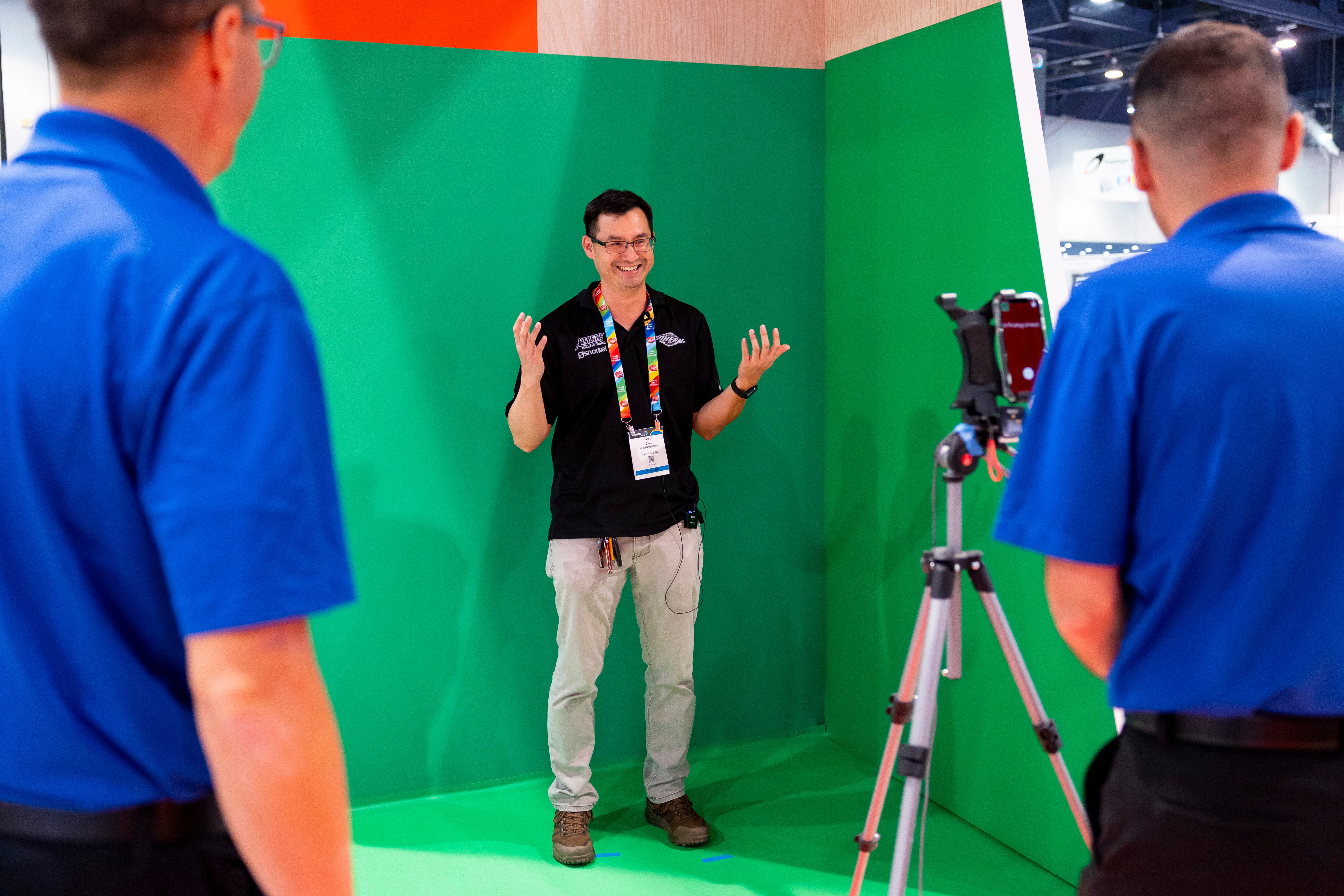 Smiling man on green screen getting his photo taken