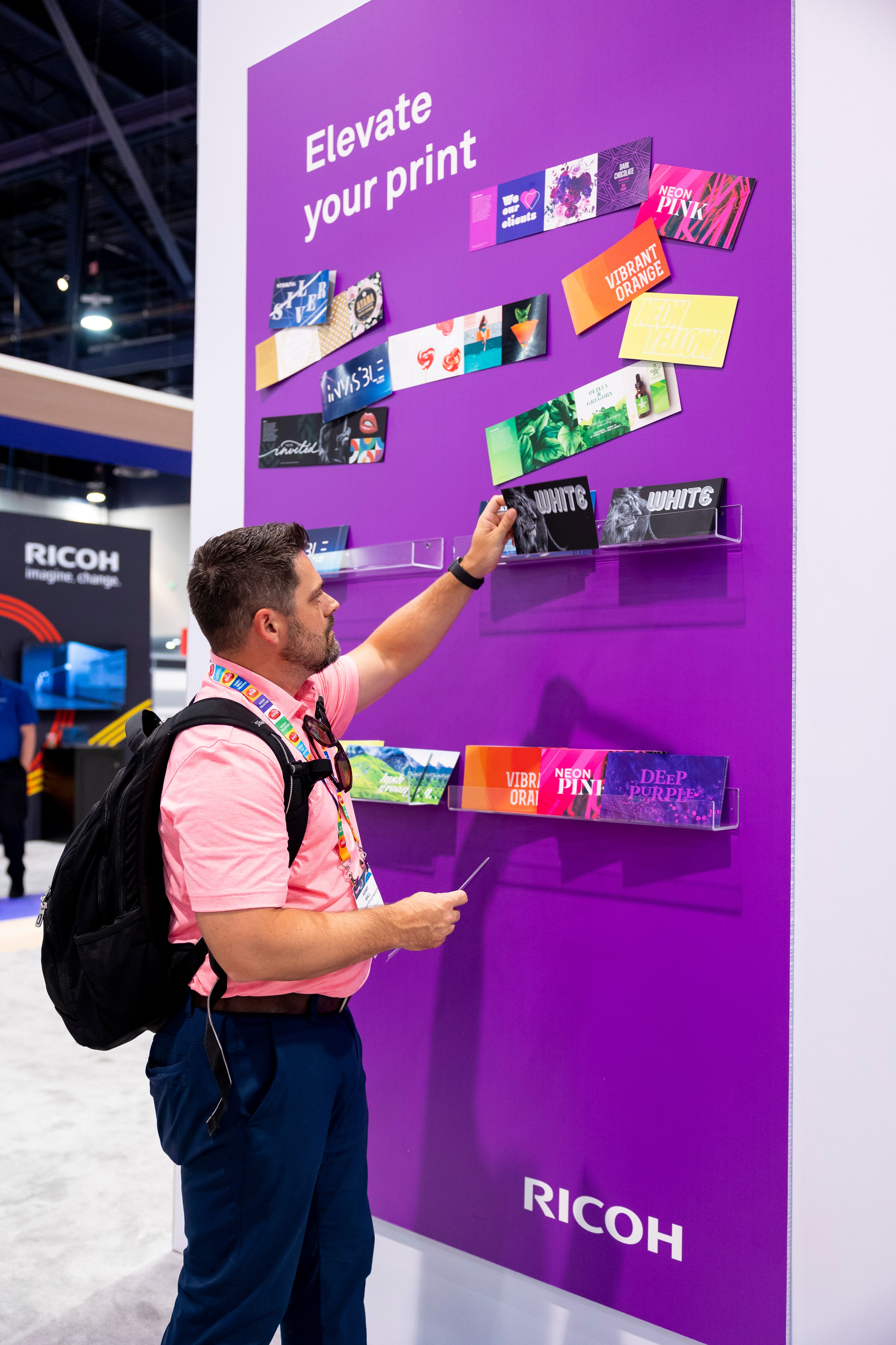 Man looking at swag on purple wall
