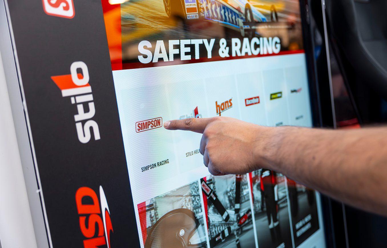 Attendee interacting with a touchscreen display at a trade show booth
