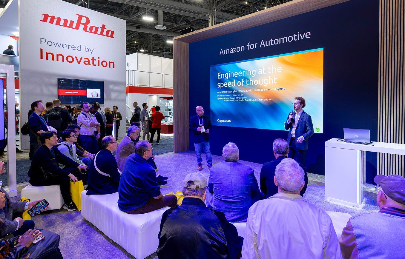 Presenter giving a product demonstration to a seated audience at a trade show booth